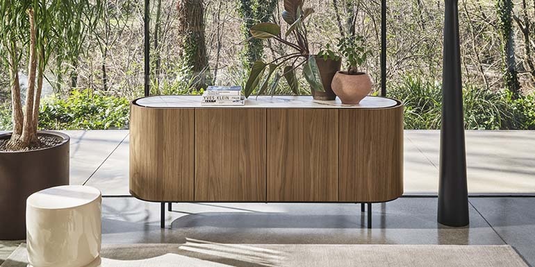 Create space where it’s needed and enrich your home with elegant solutions for organisation and storage. The Lake sideboard is a stunning piece which stands apart with its sleek curved lines. The sideboard has space-saving curved doors at either end, and sits on elegant narrow legs. Its beauty is enhanced by a ceramic top which is slightly set back from the edge, creating a practical space between door and top for opening the doors and drawers. A wonderfully flexible design, Lake comes in various sizes and finishes.